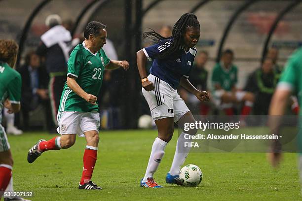 Mercy Akide-Udoh of FIFA Legends battles for the ball with Manuel Negrete of MexicanAllstars during an exhibition match between FIFA Legends and...