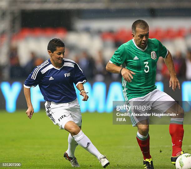 Sissi of FIFA Legends battles for the ball with Juan de Dios Ramirez Perales of MexicanAllstars during an exhibition match between FIFA Legends and...