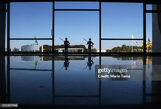 Ceremonial guards stand watch at the Planalto presidential palace a day after the Senate voted to accept impeachment charges against suspended...