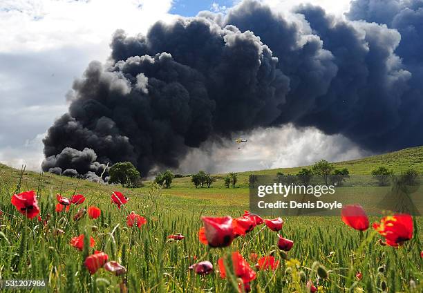 Toxic smoke rises over the Castilla La Mancha countryside after an illegal tyre dump went on fire on May 13, 2016 in Sesena Nuevo, Spain. The dump,...