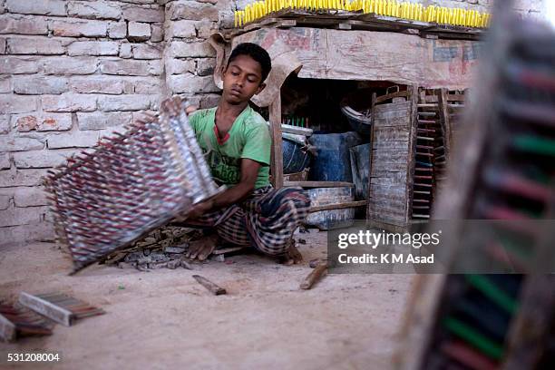 Years old Bangladeshi boy works in a balloon factory at Kamrangir Char in Dhaka, Bangladesh, April 29, 2014. In Bangladesh, at least 7.4 million...