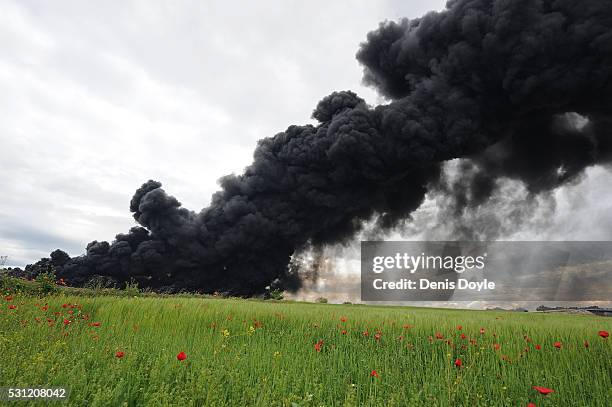 Toxic smoke rises over the Castilla La Mancha countryside after an illegal tyre dump went on fire on May 13, 2016 in Sesena Nuevo, Spain. The dump,...