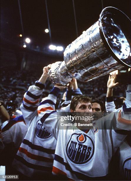 Wayne Gretzky of the Edmonton Oilers holds the Stanley Cup after Game 7 of the 1987 Stanley Cup Finals against the Philadelphia Flyers on May 31,...