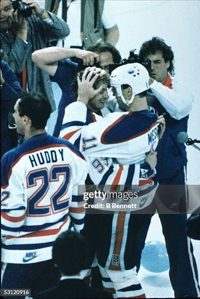 Wayne Gretzky and Mark Messier of the Edmonton Oilers embrace each other after defeating the Philadelphia Flyers in Game 7 of the 1987 Stanley Cup...