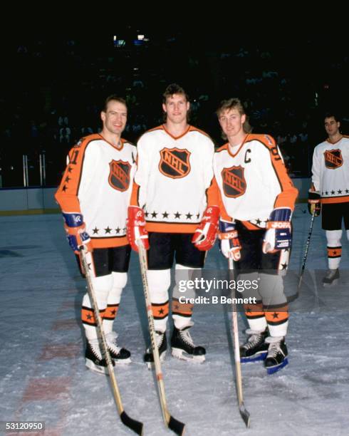 Mark Messier of the Campbell Conference and the Edmonton Oilers poses for a portrait with teammates, Bob Probert of the Detroit Red Wings and Wayne...