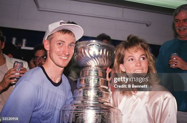 Wayne Gretzky of the Edmonton Oilers and wife Janet Jones celebrate after the Edmonton Oilers defeated the Boston Bruins in Game 5 of the 1988...