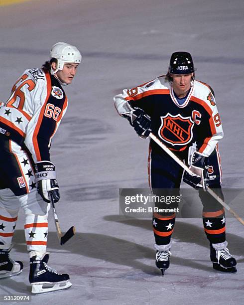 Wayne Gretzky of the Campbell Conference and the Los Angeles Kings is defended by Mario Lemieux of the Wales Conference and the Pittsburgh Penguins...