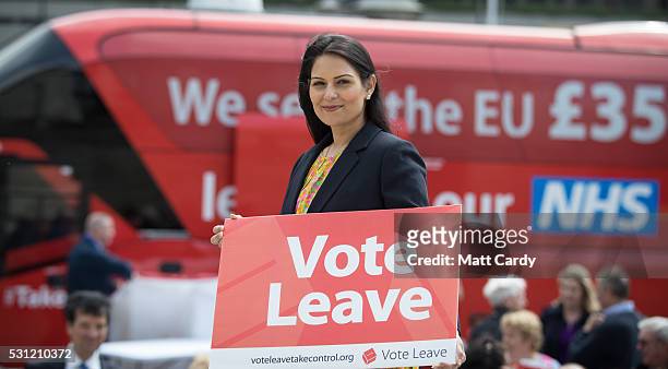 Conservative MP and Minister of State for Employment, Priti Patel holds a Vote Leave poster as she joins the Vote Leave battle bus tour as it stops...