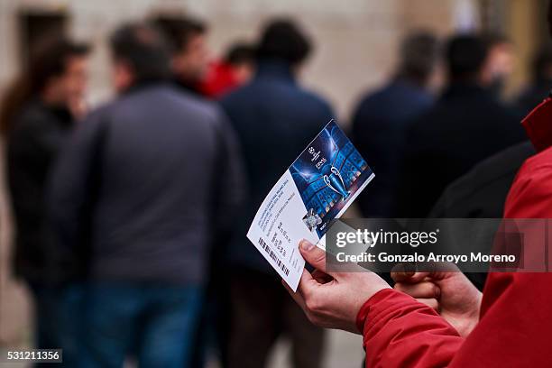 An Atletico de Madrid fan holds his ticket for the UEFA Champions League Final between Club Atletico de Madrid and Real Madrid CF after queueing up...