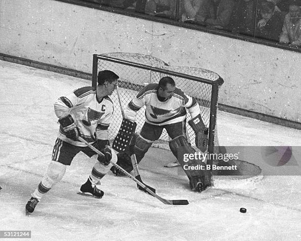 Al Arbour helps out Glenn Hall.