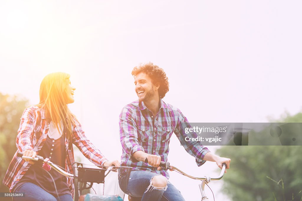Cheerful Couple Riding Bicycles Together.