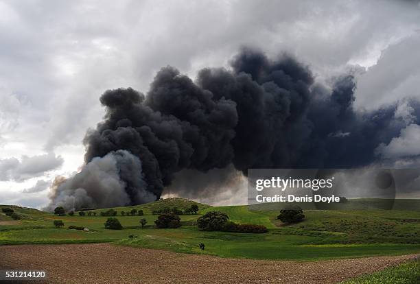 Toxic smoke rises over the Castilla La Mancha countryside after an illegal tyre dump went on fire on May 13, 2016 in Sesena Nuevo, Spain. The dump,...