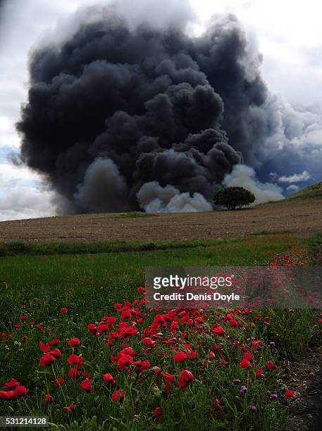 Toxic smoke rises over the Castilla La Mancha countryside after an illegal tyre dump went on fire on May 13, 2016 in Sesena Nuevo, Spain. The dump,...