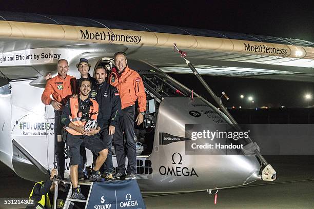 Swiss pilot Bertrand Piccard and alternate pilot Andre Boschberg , also of Switzerland, react with crew members infront of Solar Impulse 2 , the...