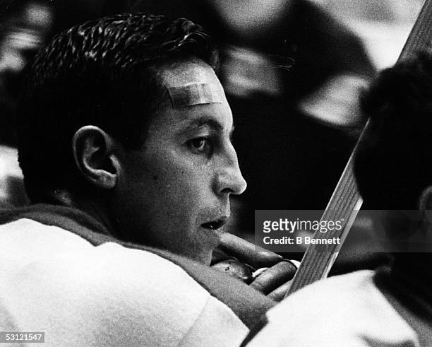 Jean Beliveau of the Montreal Canadiens looks on from the bench during an NHL game against the New York Rangers on October 24, 1965 at the Madison...