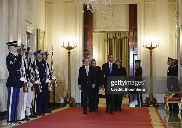 President Barack Obama, right, escorts Sauli Niinisto, Finland's president, left, and other Nordic leaders through the Cross Hall during a welcoming...