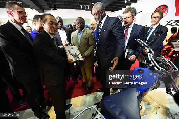 President, CEO Yamaha Motor Hiroyuki Yanagi presents books to Lagos State Gover Akinwunmi Ambode , as chairman CFAO Yamaha Motors, Gbenga Oyebode and...