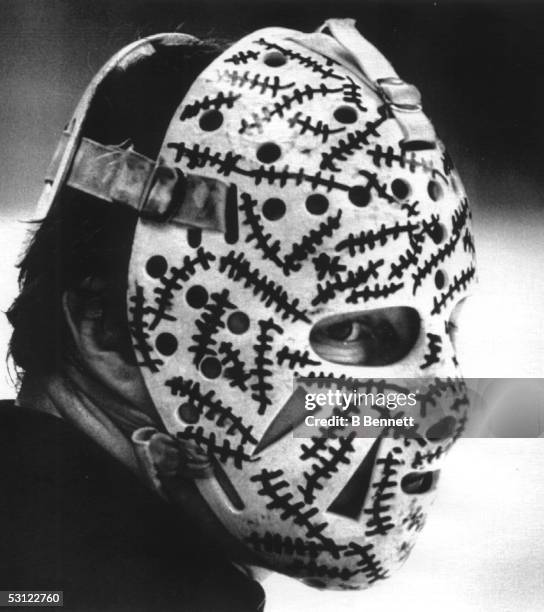 Goalie Gerry Cheevers of the Boston Bruins peers out from behind his mask during the Bruins practice session on May 20, 1978 before Game 4 of the...