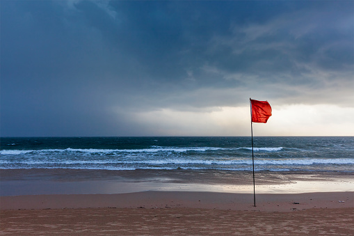 Storm warning flags on beach. Baga, Goa, India