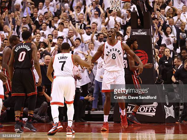 Bismack Biyombo and Kyle Lowry of the Toronto Raptors celebrate during game five of the NBA Eastern Conference Semi Finals against the Miami Heat at...