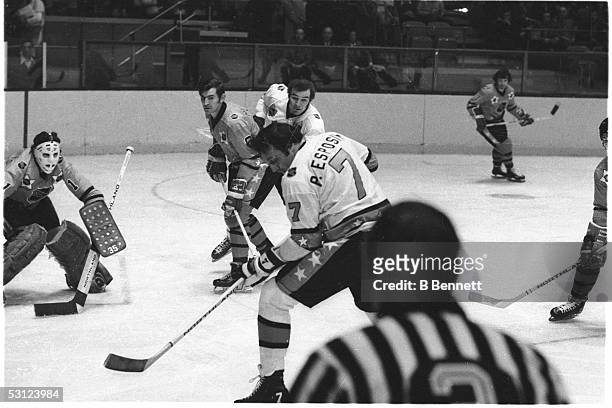 Phil Esposito of the Boston Bruins and Team East looks to shoot against his brother Tony Esposito of the Chicago Blackhawks and Team West as Ken...