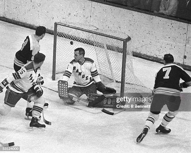 Phil Esposito and Ken Hodge of the Boston Bruins beat Ed Giacomin of the New York Rangers during a game in the 1960's at Madison Square Garden in New...