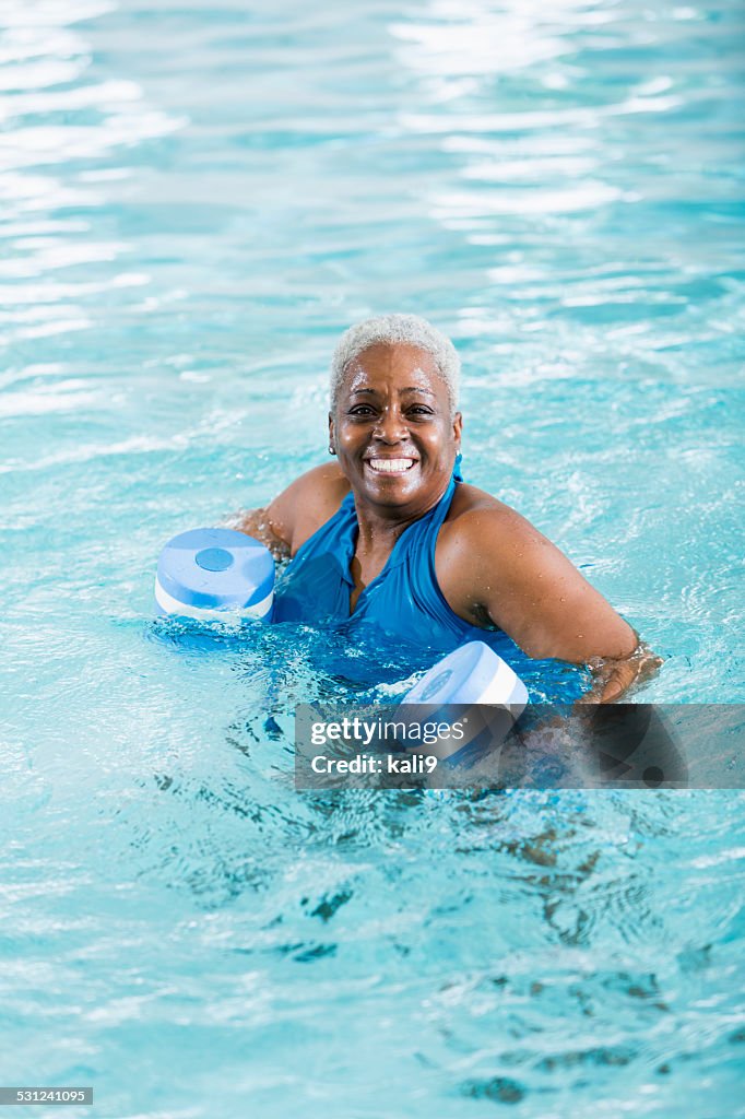 Senior black woman exercising, doing water aerobics