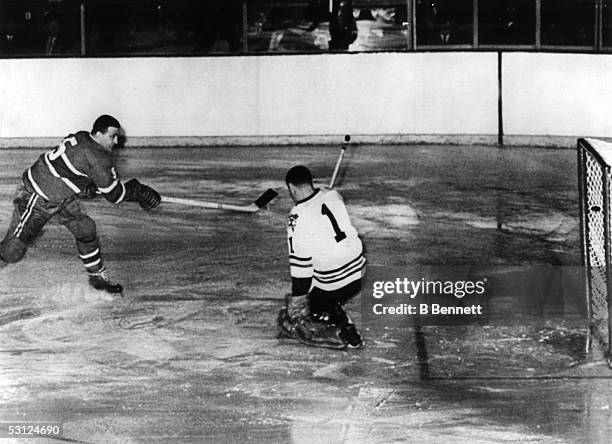 Bernie Boom Boom" Geoffrion of the Montreal Canadiens scores a goal on goalie Glen Hall of the Chicago Blackhawks during the Stanley Cup Semi-Finals...