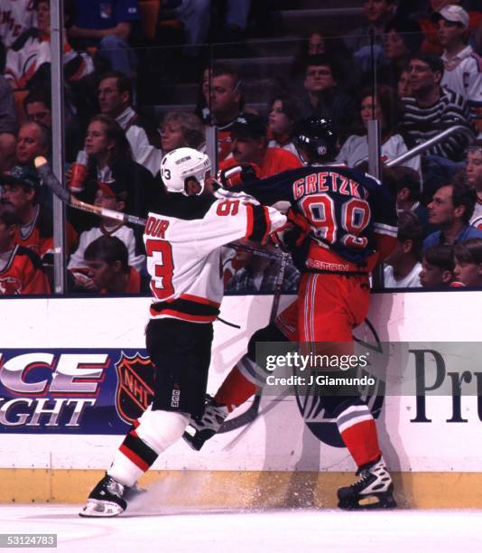 Hard hits like this one by Doug Gilmour on Wayne Gretzky have been common in the war between the Rangers and Devils And Player Wayne Gretzky.
