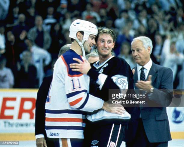 Mark Messier of the Edmonton Oilers congratulates Wayne Gretzky of the Los Angeles Kings after Gretzky scored the 1,851st point of his career as...