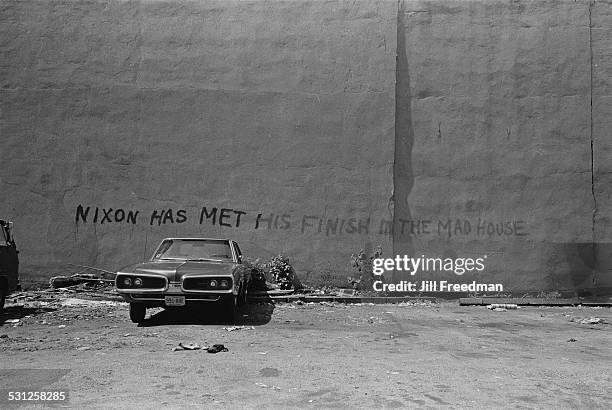 Graffiti reading 'Nixon has met his finish in the mad house', New York City, circa 1976.