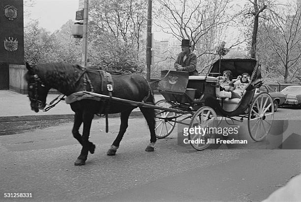 Horsedrawn carriage takes a young couple on a ride through Central Park, New York City, circa 1976.