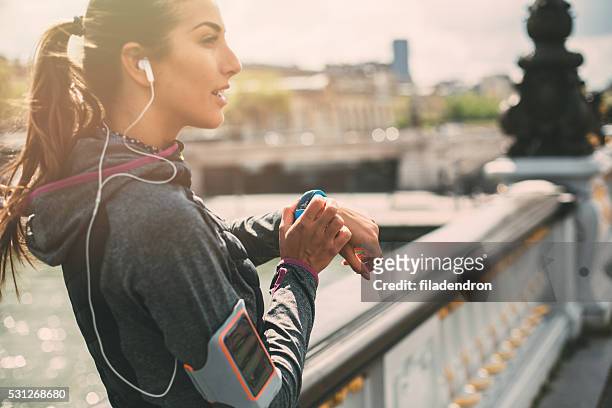 runner using smart watch - checking sports stock pictures, royalty-free photos & images