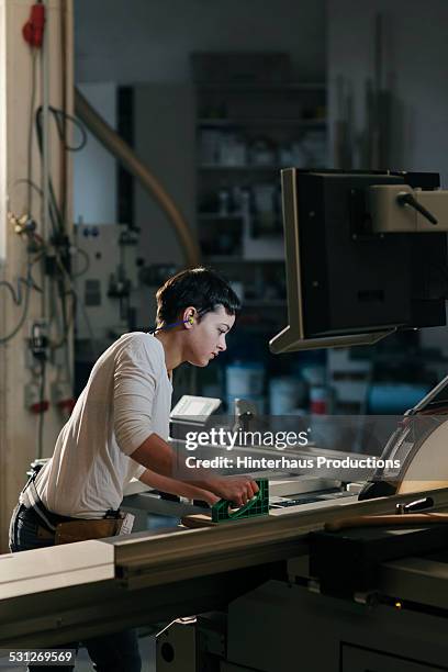 female carpenter working in workshop - genderblend2015 stock pictures, royalty-free photos & images