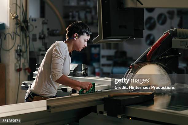 female carpenter working in workshop - wood accuracy stock pictures, royalty-free photos & images