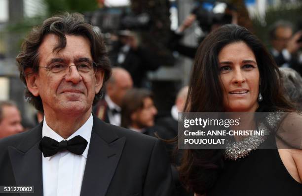 French philosopher Luc Ferry and his wife Marie-Caroline Becq de Fouquieres pose on May 13, 2016 as they arrive for the screening of the film "Ma...