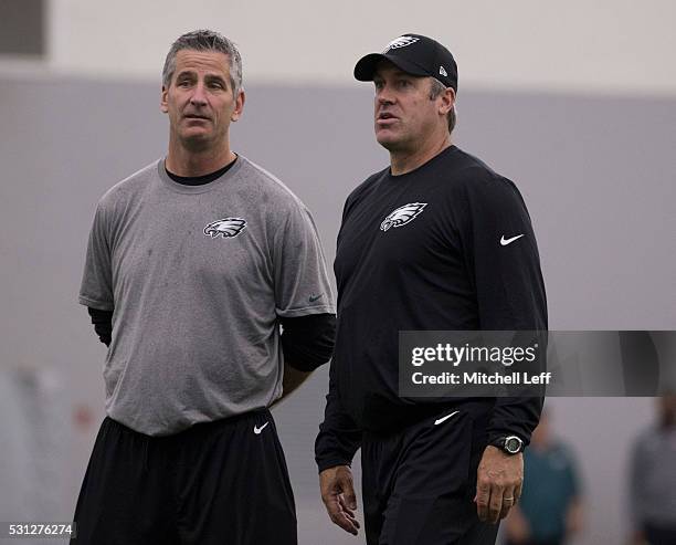 Offensive coordinator Frank Reich and head coach Doug Pederson of the Philadelphia Eagles look on during rookie camp at the NovaCare Complex on May...