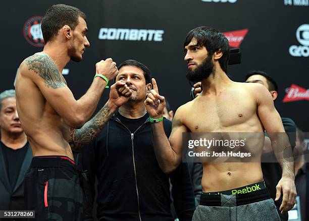 Opponents Renato Moicano of Brazil and Zubaira Tukhugov of Russia face off during the UFC 198 weigh-in at Arena da Baixada stadium on May 13, 2016 in...