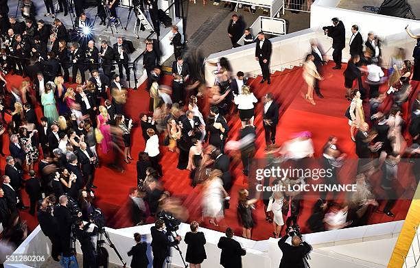 Guests arrive on May 13, 2016 for the screening of the film "La Danseuse " at the 69th Cannes Film Festival in Cannes, southern France. / AFP / LOIC...