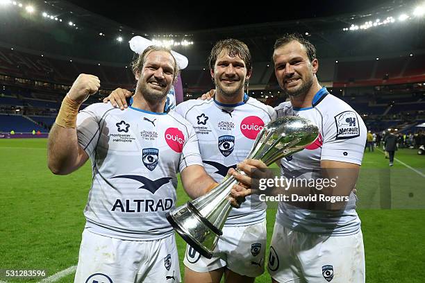 Jannie Du Plessis, Francois Steyn and Bismarck Du Plessis of Montpellier celebrate with the trophy following their team's 26-19 victory during the...