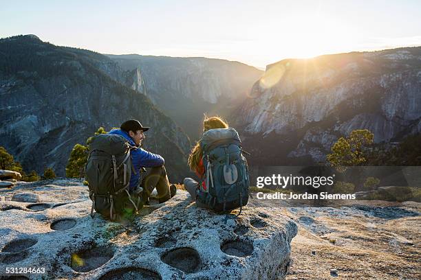 a couple backpacking in the mountains. - camping backpack stock pictures, royalty-free photos & images