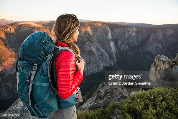 a woman backpacking. - school bag stock-fotos und bilder