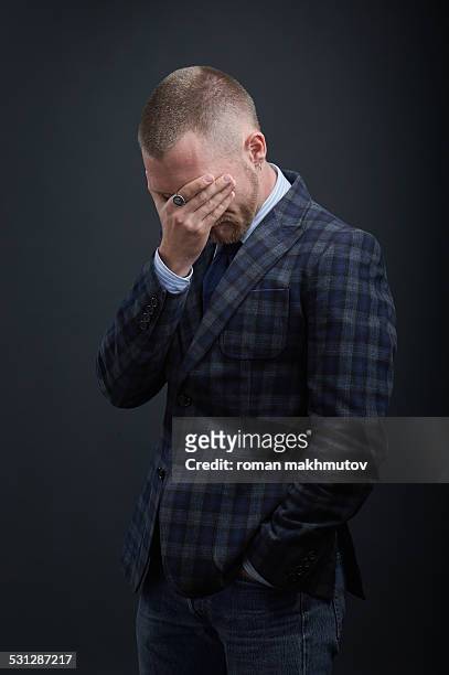 man feeling sadness covered his face with a hand - checked suit stock pictures, royalty-free photos & images