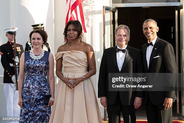 To R, Jenni Haukio, First Lady Michelle Obama, President of Finland Sauli Niinisto, and U.S. President Barack Obama pose for a group photo during...