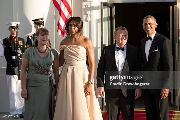 To R, Solrun Lokke Rasmussen, First Lady Michelle Obama, Prime Minister of Denmark Lars Lokke Rasmussen, and U.S. President Barack Obama pose for a...