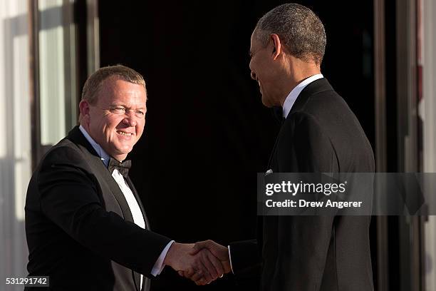 To R, Prime Minister of Denmark Lars Lokke Rasmussen shakes hands with U.S. President Barack Obama during arrivals for the Nordic state dinner at the...