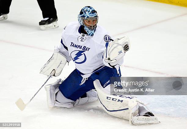 Ben Bishop of the Tampa Bay Lightning makes a glove save during the first period against the Pittsburgh Penguins in Game One of the Eastern...