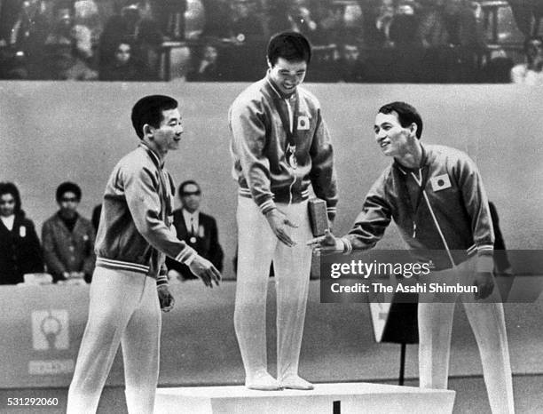 Silver medalist Noriaki Nakayama, gold medalist Sawao Kato and bronze medalist Takeshi Kato of Japan celebrates on the podium at the medal ceremony...