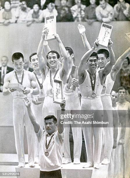 Gold medalists Akinori Nakayama, Takeshi Kato, Yukio Endo Eizo Kenmotsu, Mitsuo Tsukahara, Sawao Kato of Japan celebrate on the podium at the medal...