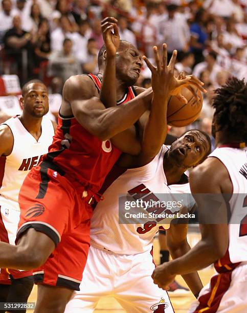 Bismack Biyombo of the Toronto Raptors and Luol Deng of the Miami Heat battle for a loose ball during Game 6 of the Eastern Conference Semifinals of...